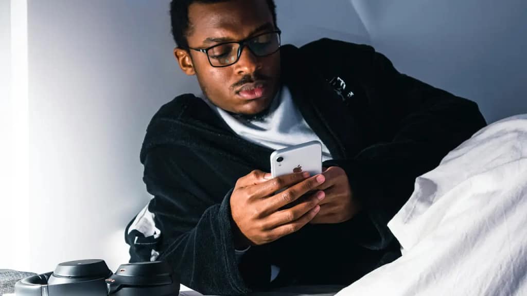 Insomnia Man playing on his phone in the middle of the night