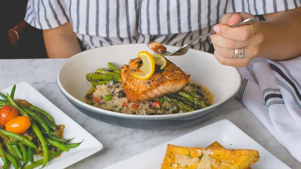 Paleo diet foods including vegetables, fish, eggs, nuts and fruit