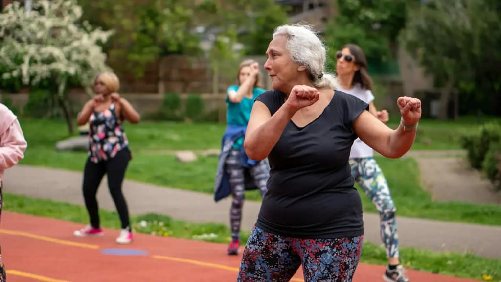 Fitness for Older Adults - Elderly people exercising in a park.