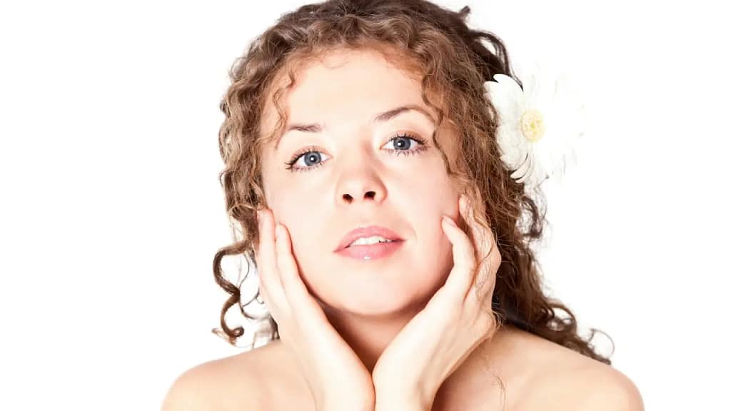 Woman with dry skin using a moisturiser as part of a simple skincare routine