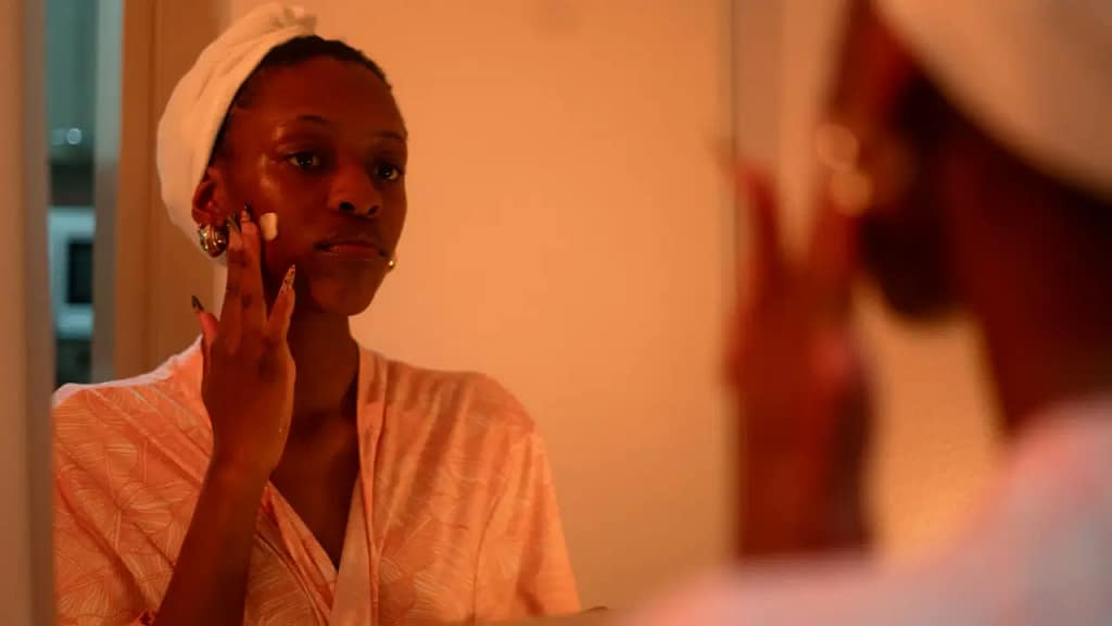 Woman with dry skin using a moisturiser as part of a simple skincare routine