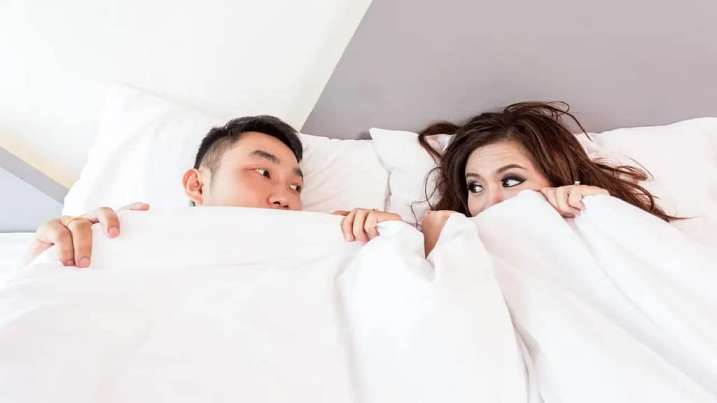 Snoring: Causes, Treatments Man & Woman laying awake because of snoring.