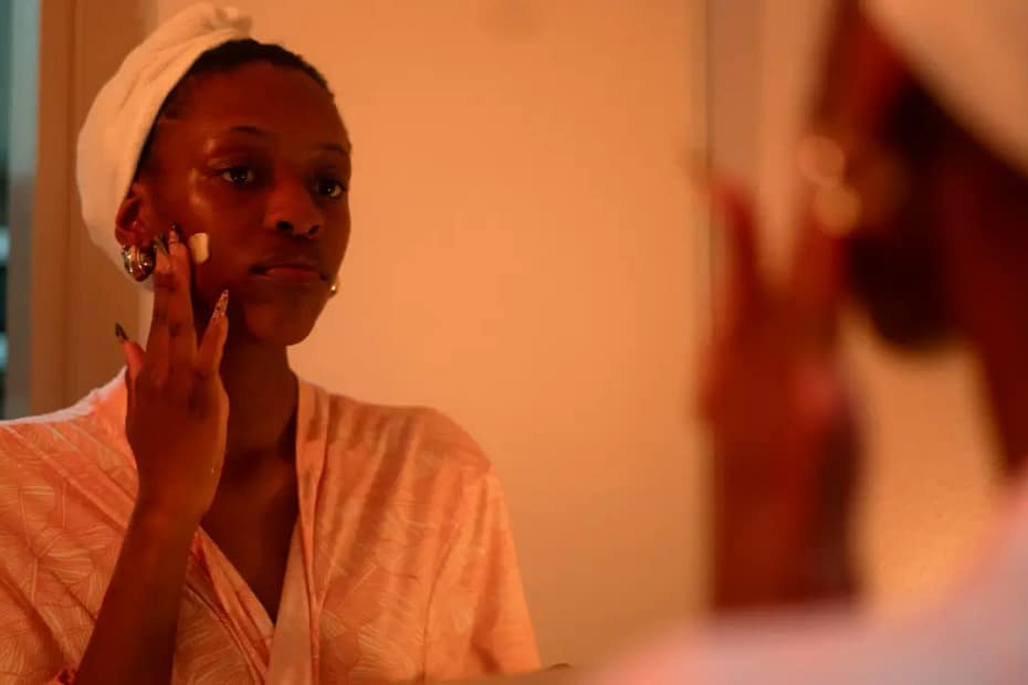 Woman with dry skin using a moisturiser as part of a simple skincare routine